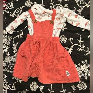 Size 6-9 months mushroom print onesie underneath a coral overall dress